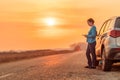 Woman text messaging roadside assistance help after car broke down Royalty Free Stock Photo