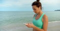 woman texting a massage on the smartphone, she walks outdoors the beach and chatting via what& x27;s up