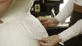 Woman in 19th-century corset. Stock footage. Close-up of maid helping her mistress dress in corset. Details of this