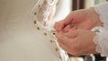 Woman in 19th-century corset. Stock footage. Close-up of maid helping her mistress dress in corset. Details of this