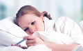 Woman with thermometer sick colds, flu, fever in bed Royalty Free Stock Photo