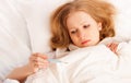 Woman with thermometer sick colds, flu, fever in bed Royalty Free Stock Photo