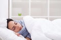 Woman with thermometer sick colds, flu, fever, headache in bed