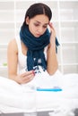 Woman with thermometer sick colds, flu, fever, headache in bed Royalty Free Stock Photo