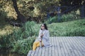 Woman with a thermos sitting in the autumn park