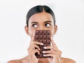 Woman, thinking and chocolate in sweet diet or unhealthy eating against a white studio background. Female person or Royalty Free Stock Photo