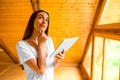 Woman thinking with digital tablet in the wooden Royalty Free Stock Photo