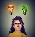 Woman thinking looking up at junk food and green vegetables light bulb Royalty Free Stock Photo