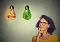 Woman thinking looking up at junk food and green vegetables shaped as light bulb Royalty Free Stock Photo