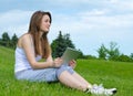 Woman thinking with a tablet in her hands Royalty Free Stock Photo