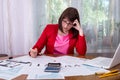Woman thinking at 1040 tax form in office