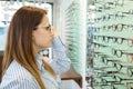 woman thinking to choose contact eyeglasses