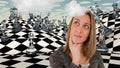 Woman thinks before chessboard