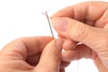 Woman threading sewing needle on white background, closeup