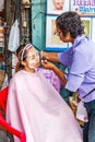 Woman threading a womans face