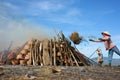 Woman throw rice traw to make flare up to burn pot