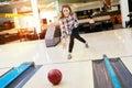 Woman throwing bowling ball Royalty Free Stock Photo