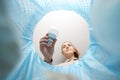 woman throwing light bulb into trash can