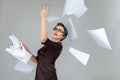 Woman throwing paper pages