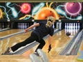 A woman throws a bowling ball on the track