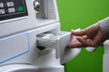 Woman throws laundry detergent into the washing machine close-up. Royalty Free Stock Photo