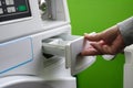 Woman throws laundry detergent into the washing machine close-up. Royalty Free Stock Photo