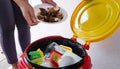 The woman throws the leftovers into the garbage bin Royalty Free Stock Photo
