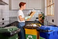 Woman throws paper carton trash in trash sorting waste, recyclable trash Royalty Free Stock Photo