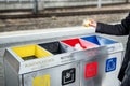 Woman throws paper trash in the trash sorting waste