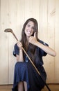 Woman thumb up in 50s dress holding a golf stick Royalty Free Stock Photo