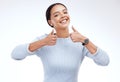 Woman, thumbs up and smile in studio portrait with happiness, confidence and success by white background. Girl, model Royalty Free Stock Photo