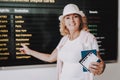 Woman with Tickets in Airport in Waiting Room.