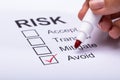 Woman Ticking Avoid Option On Risk Form