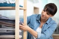 woman tidying clean laundry at home Royalty Free Stock Photo