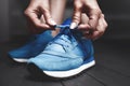 Woman ties up shoelaces on sneakers. Close up view. Healthy lifestyle concept. The girl measures new sports sneakers in the