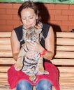 Woman with a tiger cub on her lap Royalty Free Stock Photo