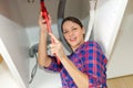 woman while tightening sink pipe with monkey wrench Royalty Free Stock Photo