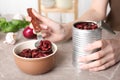 Woman with tin can of conserved beans