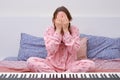 Woman is tired of playing the synthesizer, the stress of learning musical instruments at home