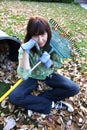 Woman Tired of Raking Autumn Leaves