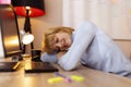 Woman tired while working in an office sleeping at her desk Royalty Free Stock Photo