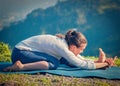 Woman in Tiryam-Mukha Eka-Pada Paschimottanasana asana stretchin