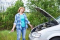 Woman with tools near broken car