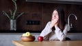 Woman with toothache eating red apple