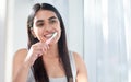 Woman, toothpaste and toothbrush for cleaning teeth, dental health or morning routine in bathroom. Girl, face in mirror Royalty Free Stock Photo