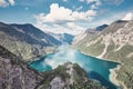 Woman on top of mountain near lake