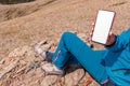 Woman on top of mountain showing white screen of her smartphone. Fitness. fitness tracker and pedometer. Cellular Communication Royalty Free Stock Photo