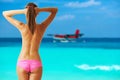 Woman topless on beach with seaplane at Maldives Royalty Free Stock Photo