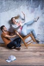 Woman on toppling chair Royalty Free Stock Photo