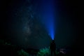 Woman with Torch sends a Light Beam to the Milky Way Royalty Free Stock Photo